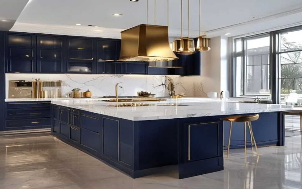 A finished navy and gold kitchen with a marble island