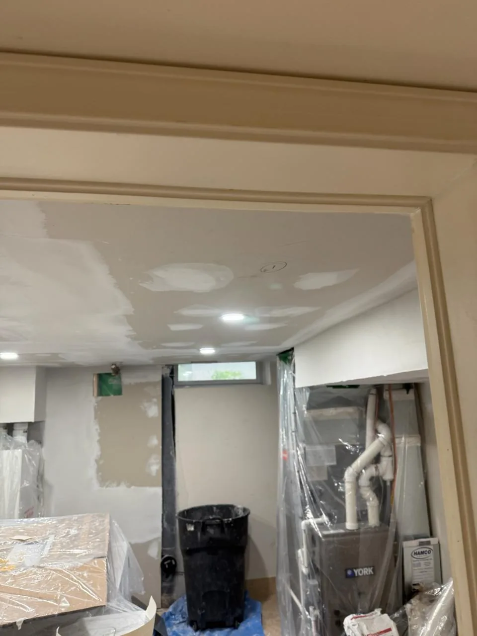 Trimmed and painted basement doorway near the end of the build
