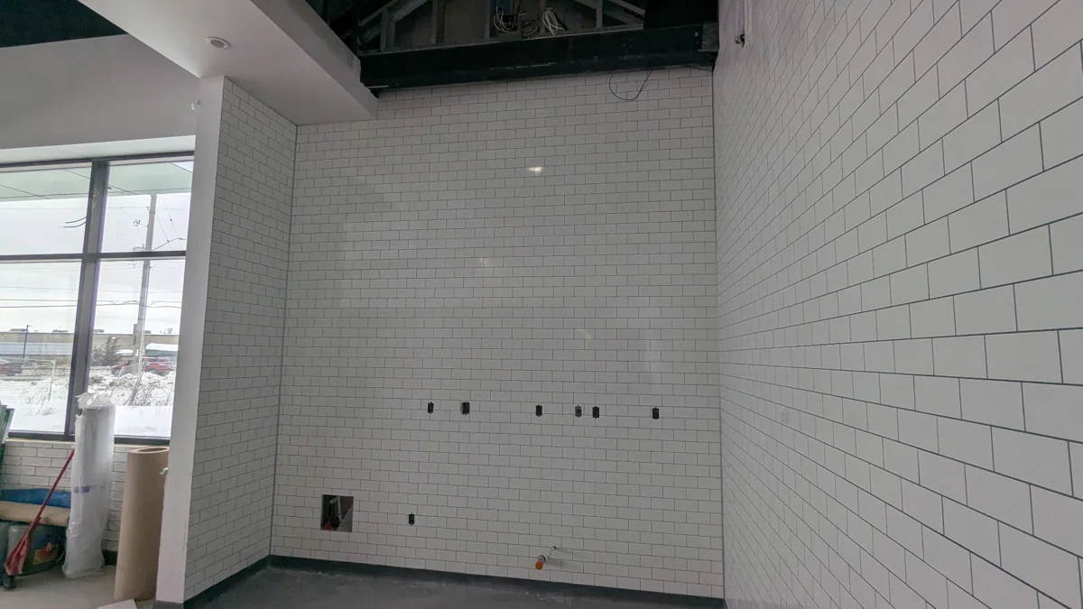 The storefront tile going up during construction