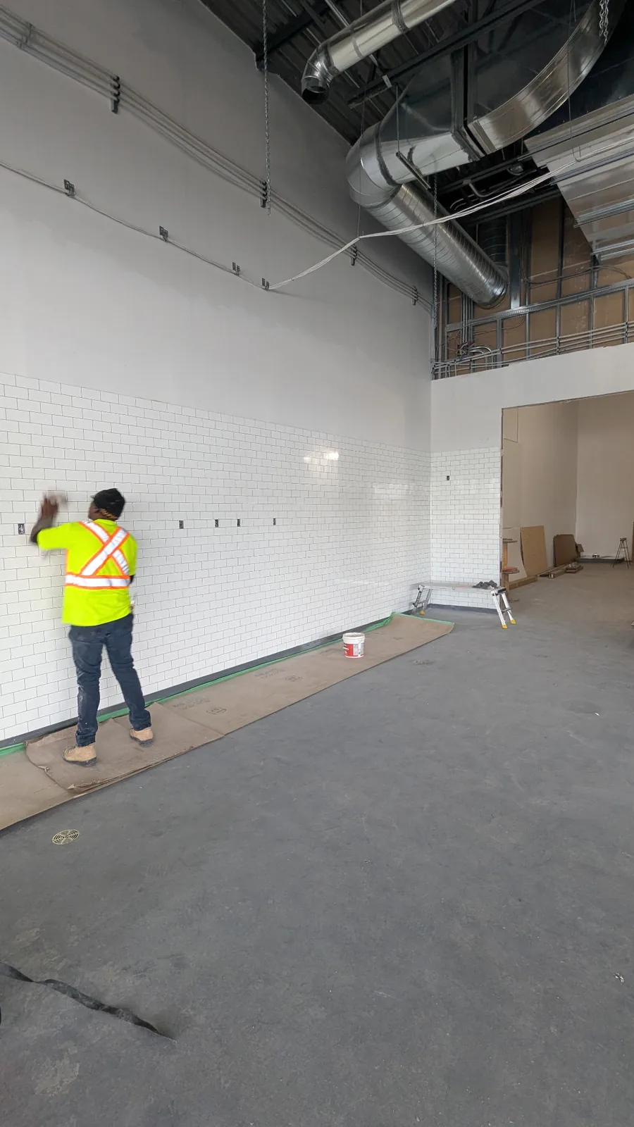 A worker taping and finishing drywall